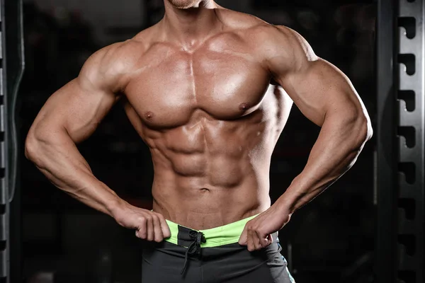 Close up strong abs guy showing in the gym muscles — Stock Photo, Image