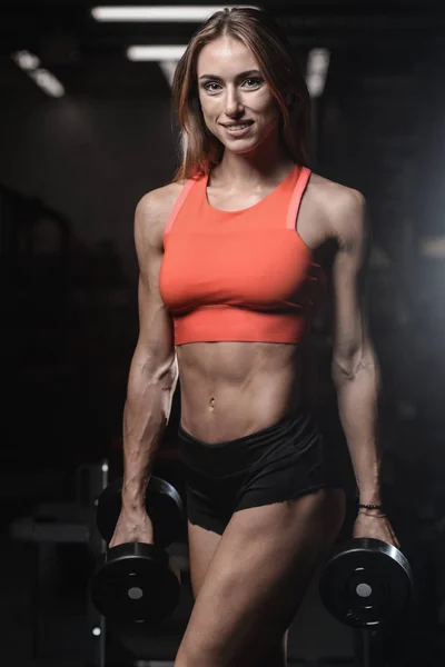 Atletische jonge vrouw die zich voordeed en uitoefening fitnesstraining met — Stockfoto