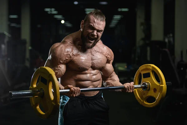 Brutal stærk bodybuilder atletiske mænd pumpe op muskler med d - Stock-foto