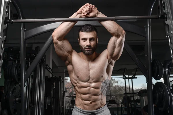 Handsome fitness model train in the gym gain muscl