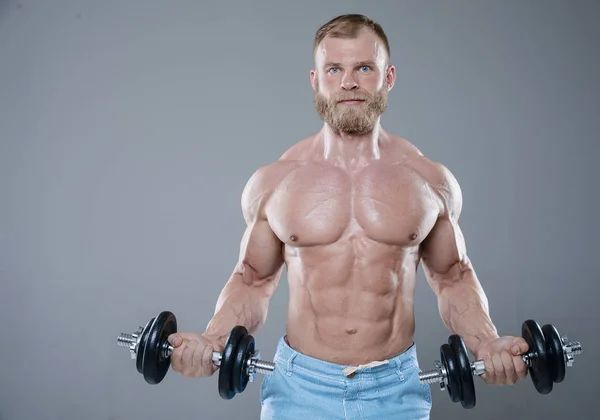 Brutale starke Bodybuilder Mann posiert im Studio auf grauem Hintergrund — Stockfoto