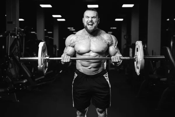 Gutaussehender Kraftsportler beim Diättraining, das Muskeln aufpumpt — Stockfoto