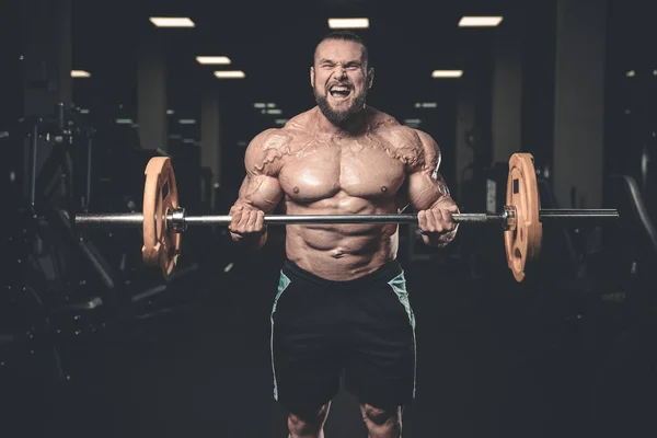 Guapo poder atlético hombre en la dieta de entrenamiento bombeo de los músculos — Foto de Stock