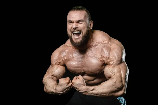 Handsome fit caucasian muscular man flexing his muscles in gym — Stock Photo, Image