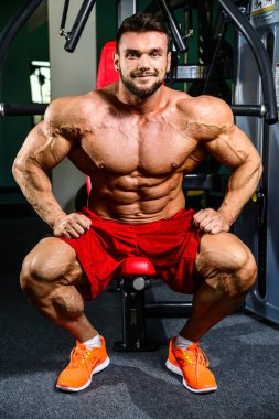 Yakışıklı uygun beyaz kas adam kasları spor salonunda esneme