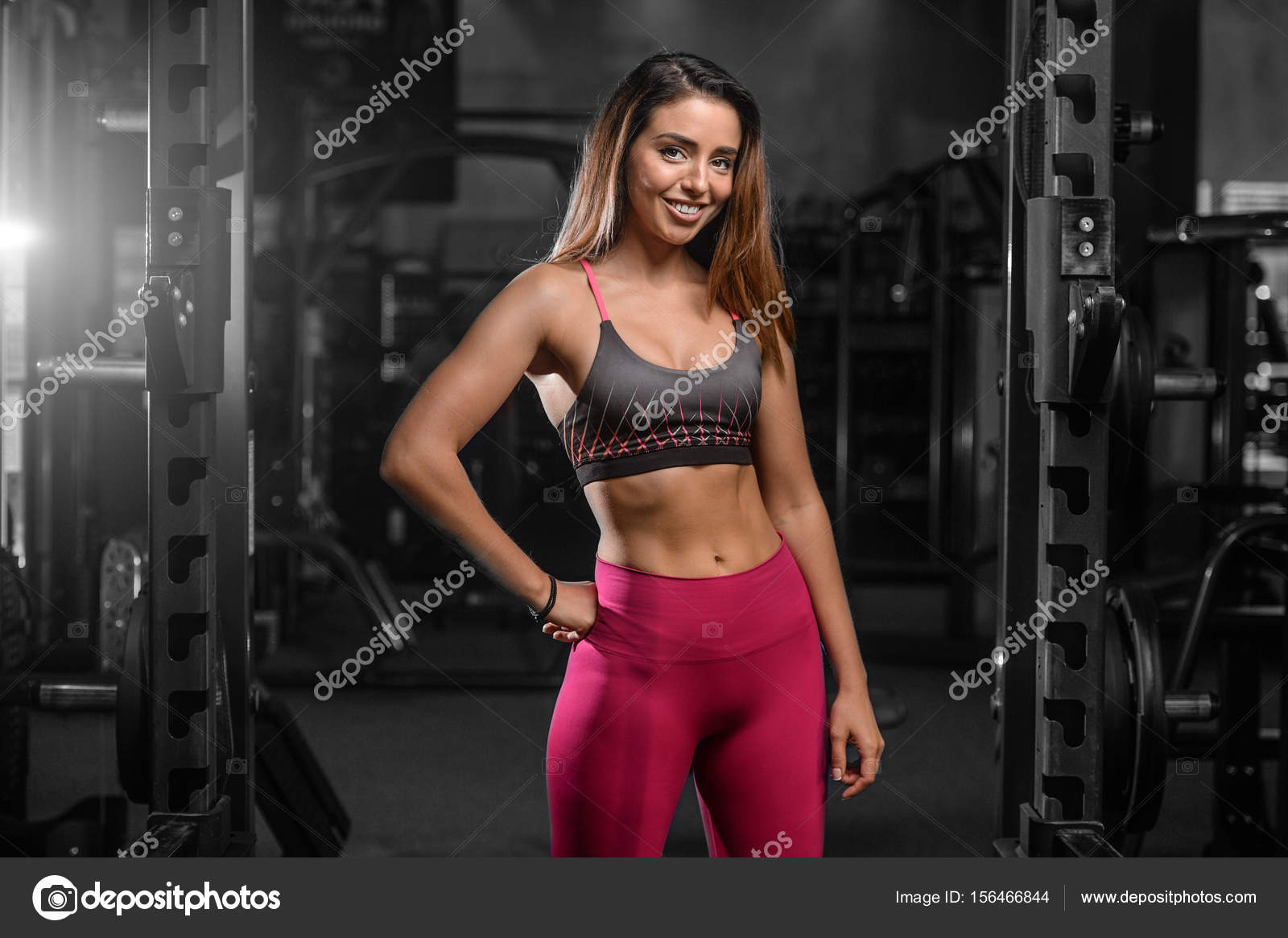 Caucasian sexy fitness female model in gym close up ab Stock Photo