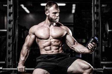 Kaslı adam egzersiz sonrası dinlenme ve Shaker içme