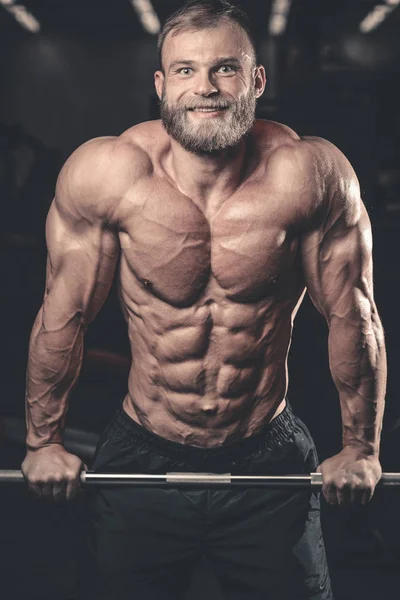 Caucasian sexy fitness male model execute exercise with barbell — Stock Photo, Image