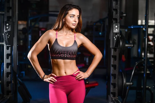 Sexy portrait model and tanned body looking away in gym — Stock Photo, Image
