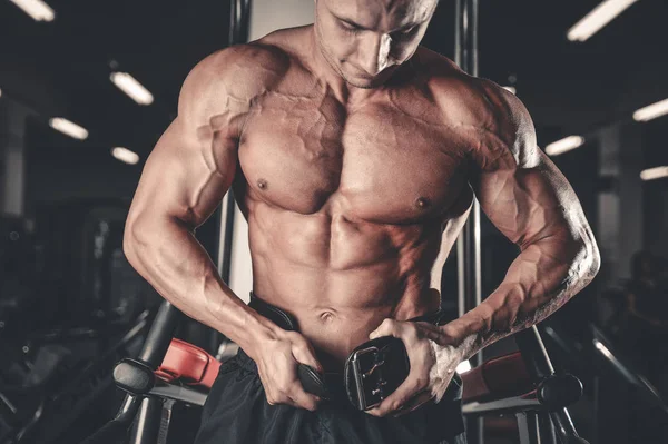 Brutal bodybuilder powerful training arms, pectorals and shoulde