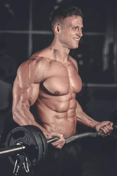 Handsome power athletic man on diet training pumping up muscles — Stock Photo, Image