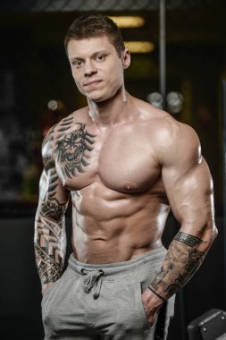 Güçlü ve yakışıklı atletik genç kaslı adam dövme 