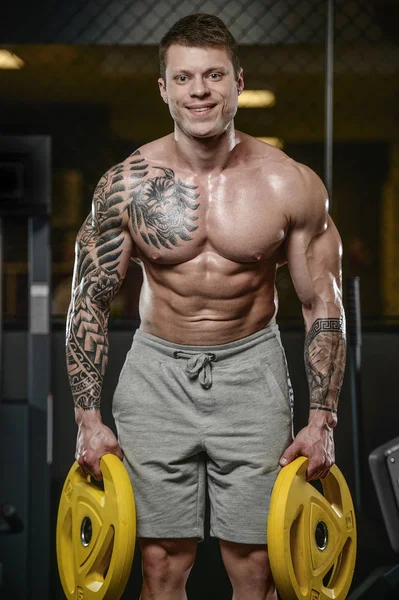 Strong and handsome athletic young tattoo man with muscles — Stock Photo, Image