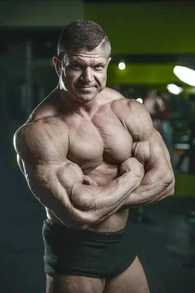 Brutal Caucasian bodybuilder working out in gym