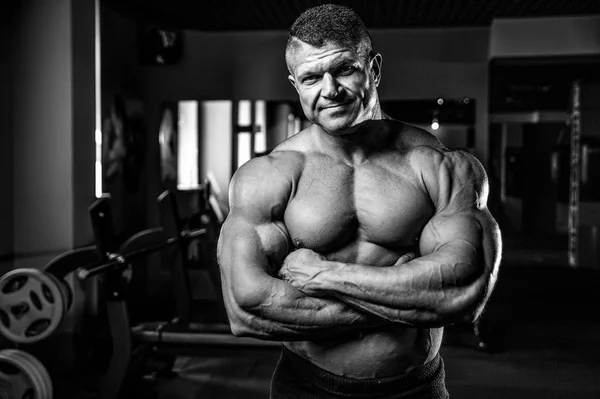 Brutal Caucasian bodybuilder working out in gym