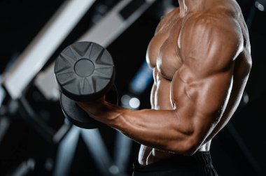 Yakışıklı model genç adam spor salonunda egzersiz
