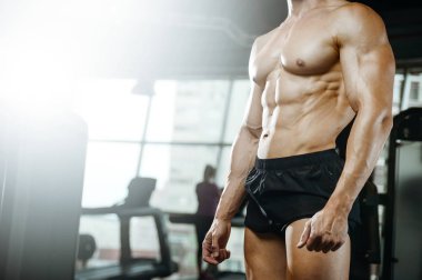 Yakışıklı model genç adam eğitim abs spor salonunda