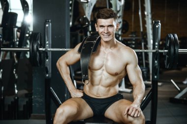 Yakışıklı model genç adam spor salonunda egzersiz
