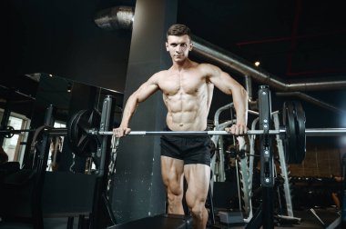 Yakışıklı model genç adam spor salonunda egzersiz