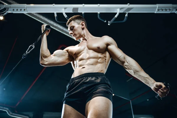 Handsome model young man training arms in gym — Stock Photo, Image