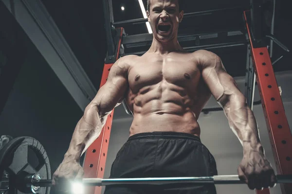 Handsome model young man training abs in gym — Stock Photo, Image