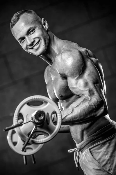 Handsome model young man training arms in gym — Stock Photo, Image