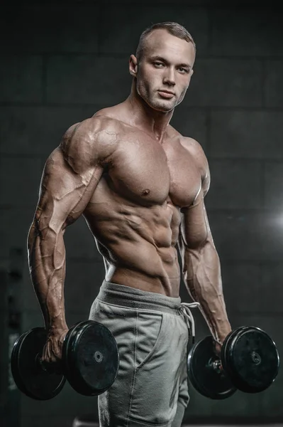 Handsome model young man training abs in gym — Stock Photo, Image