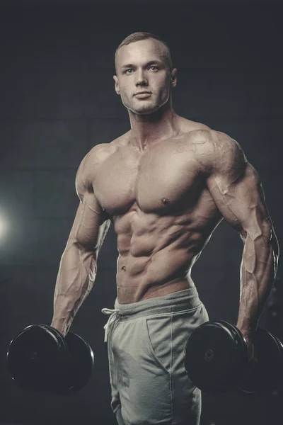 Handsome model young man training abs in gym — Stock Photo, Image