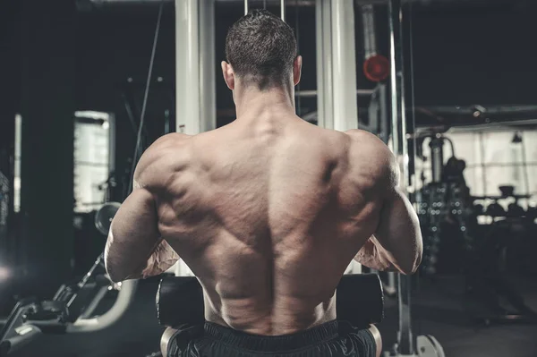 Handsome model young man training back in gym — Stock Photo, Image