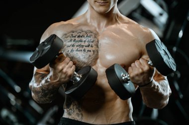 Yakışıklı model genç adam spor salonunda egzersiz