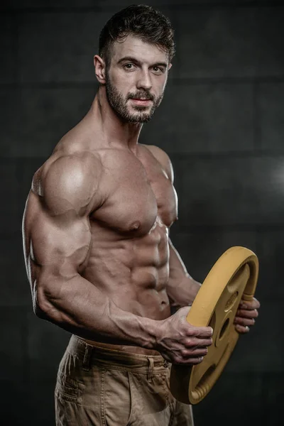 Handsome model young man training arms in gym — Stock Photo, Image