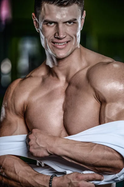 Guapo modelo joven posando en el gimnasio — Foto de Stock