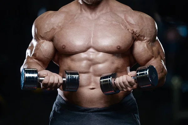 Brutal strong bodybuilder athletic men pumping up muscles with d — Stock Photo, Image