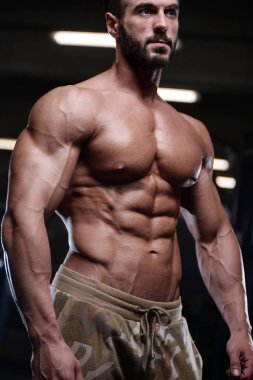 seksi güçlü vücut geliştirmeci atletik erkek dum ile kasları kadar pompalama