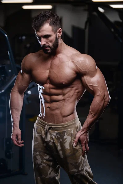 Sexy fuerte culturista atlético hombres bombeo hasta los músculos con dum — Foto de Stock