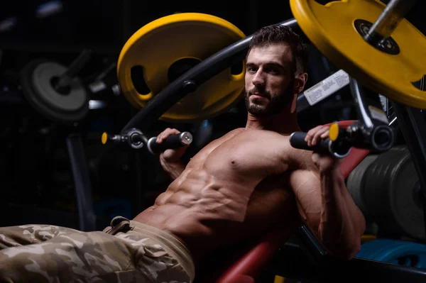 Seksi güçlü vücut geliştirmeci atletik erkek dum ile kasları kadar pompalama — Stok fotoğraf