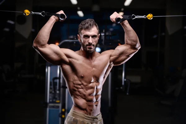 Sexy strong bodybuilder athletic men pumping up muscles with dum — Stock Photo, Image