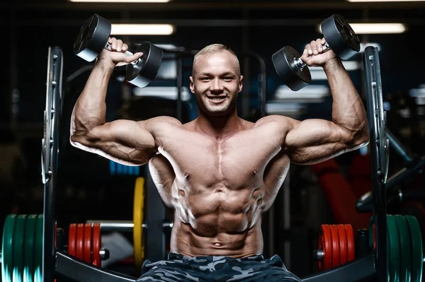 Brutale forte bodybuilder uomini atletici pompaggio muscoli con d — Foto Stock