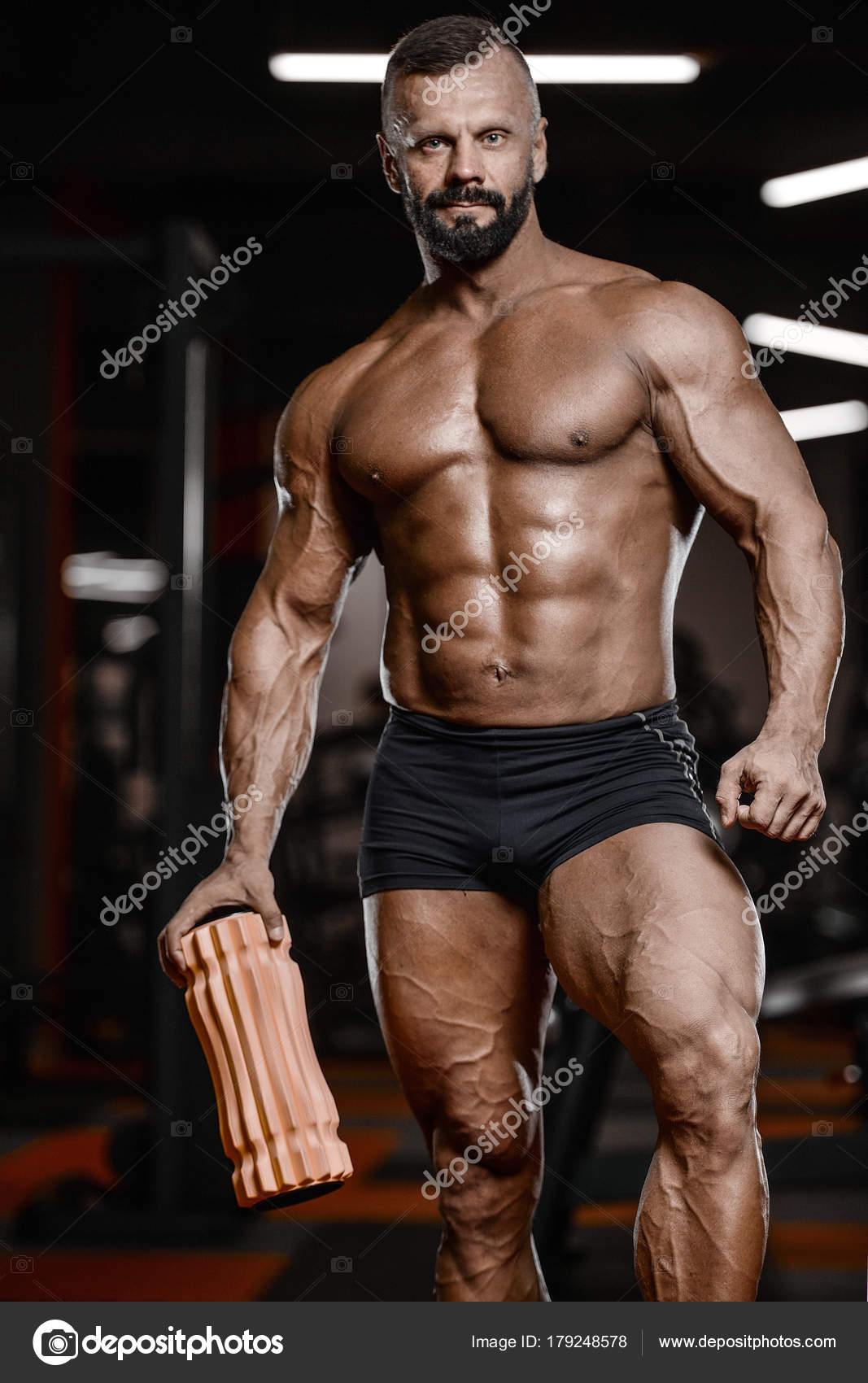 Old brutal strong bodybuilder athletic men pumping up muscles wi