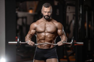 Eski acımasız güçlü vücut geliştirmeci atletik erkek pompalama kasları wi