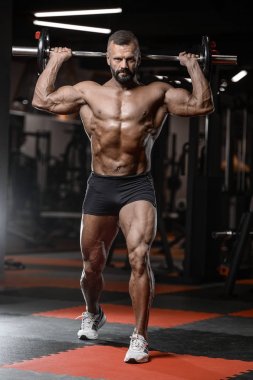 Eski acımasız güçlü vücut geliştirmeci atletik erkek pompalama kasları wi