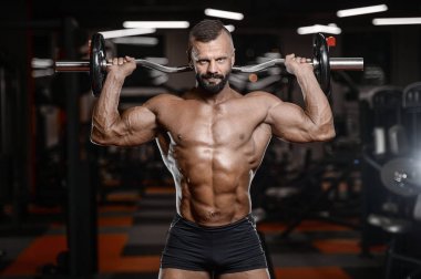 Eski acımasız güçlü vücut geliştirmeci atletik erkek pompalama kasları wi