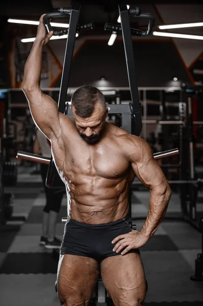 Eski acımasız güçlü vücut geliştirmeci atletik erkek pompalama kasları wi