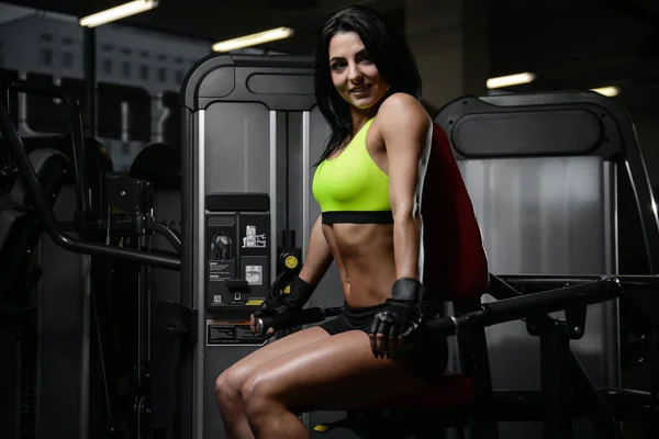 brunette sexy athletic young girl working out in gym