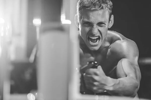 Przystojny model młody człowiek szkolenia z powrotem w siłownia — Zdjęcie stockowe