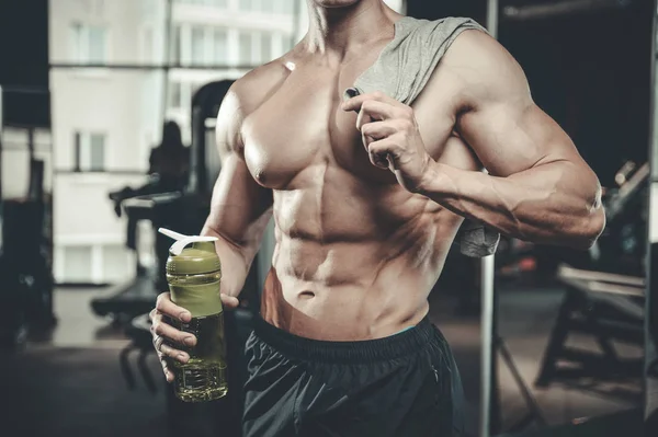 Handsome model young man takes sports nutrition — Stock Photo, Image