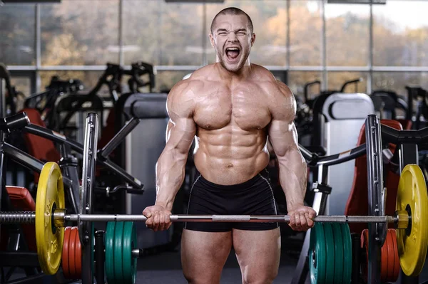 Brutal forte fisiculturista homens atléticos bombeando os músculos com d — Fotografia de Stock
