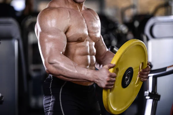 Brutal strong bodybuilder athletic men pumping up muscles with d