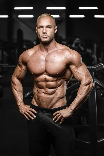 Guapo fuerte atlético hombres bombeando los músculos entrenamiento fitness —  Fotos de Stock