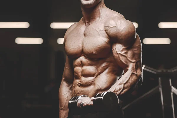 Guapo hombre atlético fuerte bombeo hasta bíceps ejercicios musculares f — Foto de Stock